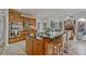 Spacious kitchen featuring wooden cabinets, stainless appliances, and an island with barstool seating at 6477 Blue Water Dr, Buford, GA 30518