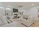 Spacious living room with a fireplace, built-in shelving, and comfortable seating arrangements at 6477 Blue Water Dr, Buford, GA 30518