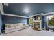 A living room features dark blue walls, white trim, a fireplace and large windows at 6477 Blue Water Dr, Buford, GA 30518