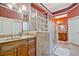 Beautiful primary bathroom with double vanity, glass shower, and ceramic tile flooring at 6477 Blue Water Dr, Buford, GA 30518