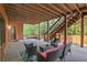 Covered outdoor patio with brick columns and a cozy seating area, perfect for relaxing at 6477 Blue Water Dr, Buford, GA 30518