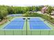 Bright blue and green community tennis courts, perfect for active residents to play and socialize at 6477 Blue Water Dr, Buford, GA 30518