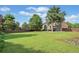 Expansive backyard featuring a lush lawn, wooden fence, and mature trees at 910 Ovalene Sw Ln, Marietta, GA 30064