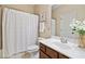 Bright bathroom features a vanity with a sink, white shower curtain and modern finishes at 910 Ovalene Sw Ln, Marietta, GA 30064
