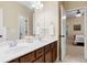 Bathroom featuring double sink vanity with wood cabinets and views of the bedroom at 910 Ovalene Sw Ln, Marietta, GA 30064