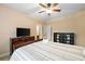 Comfortable bedroom with ceiling fan, dresser, TV, and decorative shelving at 910 Ovalene Sw Ln, Marietta, GA 30064
