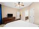 Bedroom featuring neutral decor, a dresser with a TV, and adjacent bathroom at 910 Ovalene Sw Ln, Marietta, GA 30064
