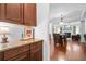 Butler pantry with rich wood cabinetry, granite countertop, and seamless transition to dining and living areas at 910 Ovalene Sw Ln, Marietta, GA 30064