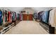 Walk-in closet with custom shelving, multiple hanging racks and drawers at 910 Ovalene Sw Ln, Marietta, GA 30064