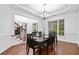 Elegant dining room showcasing tray ceilings, wainscoting, and a chandelier at 910 Ovalene Sw Ln, Marietta, GA 30064