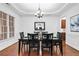 Formal dining room featuring a stylish chandelier, dark wood table with seating for six, and wainscoting at 910 Ovalene Sw Ln, Marietta, GA 30064