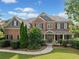 Charming two-story brick home with a covered front porch and manicured landscaping at 910 Ovalene Sw Ln, Marietta, GA 30064