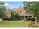 Charming two-story brick home with a well-manicured lawn and inviting front porch at 910 Ovalene Sw Ln, Marietta, GA 30064