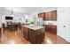Open kitchen view showcasing an island with seating, stainless steel appliances, and connection to the living spaces at 910 Ovalene Sw Ln, Marietta, GA 30064