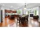 Open-concept kitchen with stainless steel appliances, wood cabinets, an island, and a seamless flow to the dining area at 910 Ovalene Sw Ln, Marietta, GA 30064