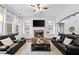 Expansive living room features a fireplace, built-in shelving, and stylish furnishings at 910 Ovalene Sw Ln, Marietta, GA 30064