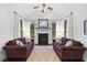 Comfortable living room features two sofas, natural light, a fireplace, and neutral décor at 910 Ovalene Sw Ln, Marietta, GA 30064