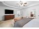 Spacious main bedroom featuring en suite bathroom, tray ceilings, and sofa at 910 Ovalene Sw Ln, Marietta, GA 30064