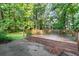 Wooden deck features natural view and cement patio at 1757 Mystery Sw Cir, Conyers, GA 30094