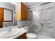 Bathroom features a white marble-like shower with a glass door, a white toilet, and a cabinet above the sink at 1757 Mystery Sw Cir, Conyers, GA 30094