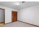 Bedroom features white walls, a closet with folding doors, carpet, and wood trim at 1757 Mystery Sw Cir, Conyers, GA 30094