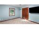 A blue bedroom includes a window, a closet with folding doors, neutral carpet, and a wall-mounted television at 1757 Mystery Sw Cir, Conyers, GA 30094