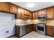 Compact kitchen featuring stainless steel appliances and wooden cabinets at 1757 Mystery Sw Cir, Conyers, GA 30094