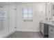 Bright bathroom featuring gray tile floors, a double vanity, and a walk-in shower with unique tile at 3323 Lancing Ct, Duluth, GA 30096