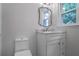 Bathroom featuring a vanity with a marble countertop and a modern mirror at 3323 Lancing Ct, Duluth, GA 30096