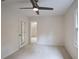 Bright bedroom with a ceiling fan, carpeted floors, and access to other rooms at 3323 Lancing Ct, Duluth, GA 30096