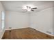 Bright bedroom with ceiling fan, hardwood floors, and a double door closet at 3323 Lancing Ct, Duluth, GA 30096