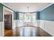 Charming dining room with wainscoting, elegant chandelier, and abundant natural light at 3323 Lancing Ct, Duluth, GA 30096