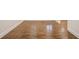Close-up of rich, dark-stained hardwood flooring with bright white trim at 3323 Lancing Ct, Duluth, GA 30096