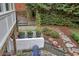 This charming stone patio features a seating area with a view of the home's well landscaped yard at 3323 Lancing Ct, Duluth, GA 30096