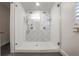 Modern shower with patterned tile, dual shower heads, and a frameless glass enclosure at 3323 Lancing Ct, Duluth, GA 30096