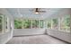 Bright sunroom featuring large windows overlooking lush greenery at 3323 Lancing Ct, Duluth, GA 30096