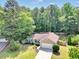 Inviting one-story home with mature trees, lush lawn, and a private backyard oasis at 5600 Walnut Creek Nw Ct, Lilburn, GA 30047