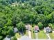 Aerial view of a home surrounded by lush trees and greenery at 5600 Walnut Creek Nw Ct, Lilburn, GA 30047