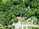 Aerial view of a home surrounded by lush trees and greenery at 5600 Walnut Creek Nw Ct, Lilburn, GA 30047