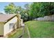 Exterior view of a home featuring a large backyard and wood fence at 5600 Walnut Creek Nw Ct, Lilburn, GA 30047