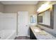 Bathroom vanity with granite countertop, dark cabinets, and tub shower at 5600 Walnut Creek Nw Ct, Lilburn, GA 30047