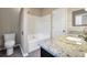 Bathroom featuring a granite countertop, soaking tub, toilet and cabinets at 5600 Walnut Creek Nw Ct, Lilburn, GA 30047
