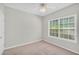 An empty bedroom featuring carpet floors and a large window for natural light at 5600 Walnut Creek Nw Ct, Lilburn, GA 30047