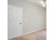 Empty bedroom with carpet, a white door, and grey walls at 5600 Walnut Creek Nw Ct, Lilburn, GA 30047