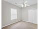 A carpeted bedroom featuring a ceiling fan, window with blinds, and a double door closet at 5600 Walnut Creek Nw Ct, Lilburn, GA 30047