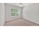 A bedroom featuring carpet flooring, a window with blinds, and light grey colored walls at 5600 Walnut Creek Nw Ct, Lilburn, GA 30047