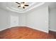 Bright bedroom with hardwood flooring, tray ceiling, and neutral paint at 5600 Walnut Creek Nw Ct, Lilburn, GA 30047