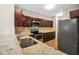 Kitchen with granite countertops, tile backsplash, stainless appliances, and dark wood cabinets at 5600 Walnut Creek Nw Ct, Lilburn, GA 30047