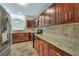 Renovated kitchen features granite countertops, tile backsplash, and dark wood cabinetry at 5600 Walnut Creek Nw Ct, Lilburn, GA 30047