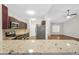 Open-concept kitchen features stainless steel appliances, granite countertops, and dark wood cabinetry at 5600 Walnut Creek Nw Ct, Lilburn, GA 30047